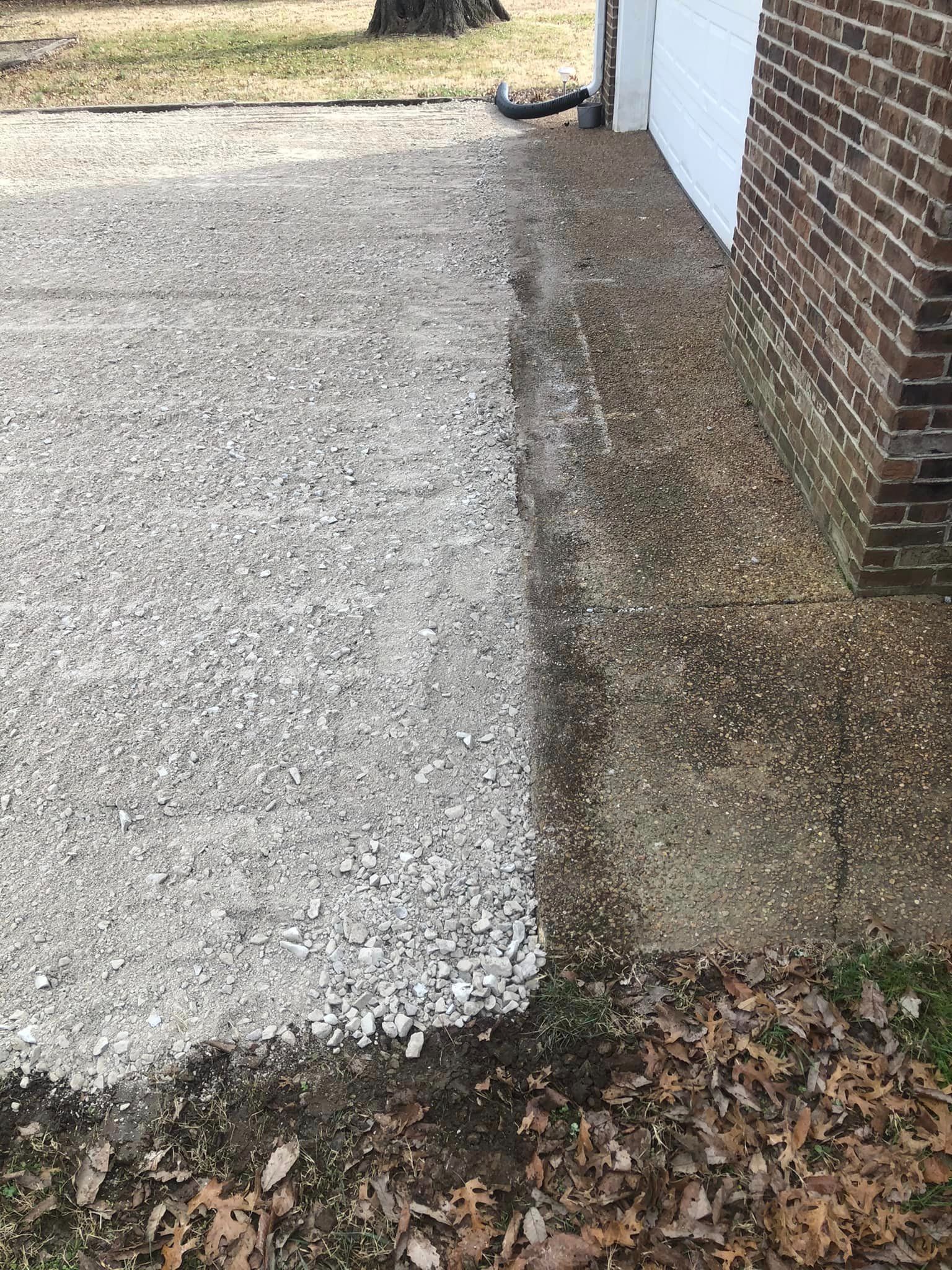 A brick building with a gravel driveway next to it.