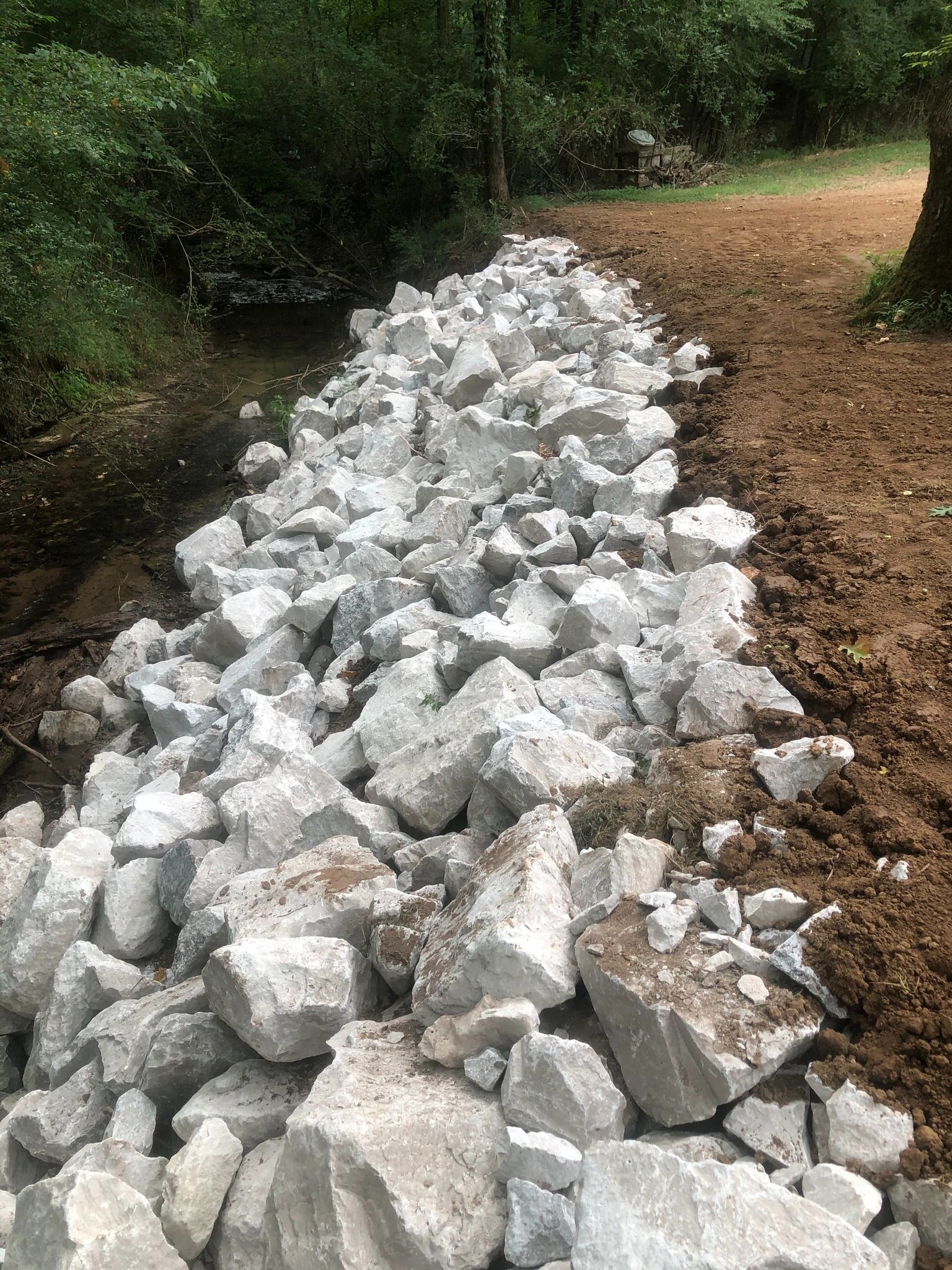 A pile of rocks sitting on top of a dirt road.