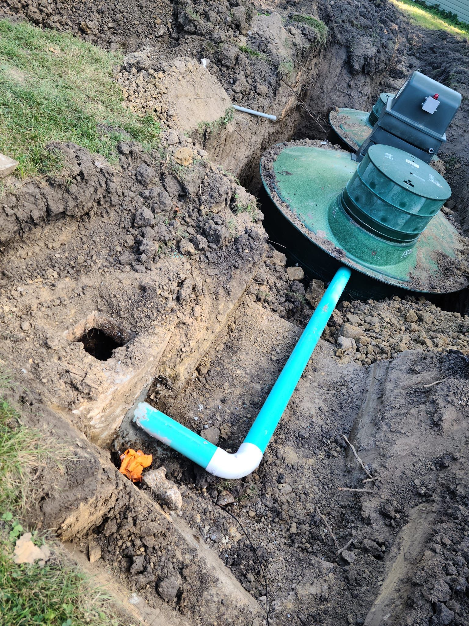 A septic tank is being installed in the dirt.