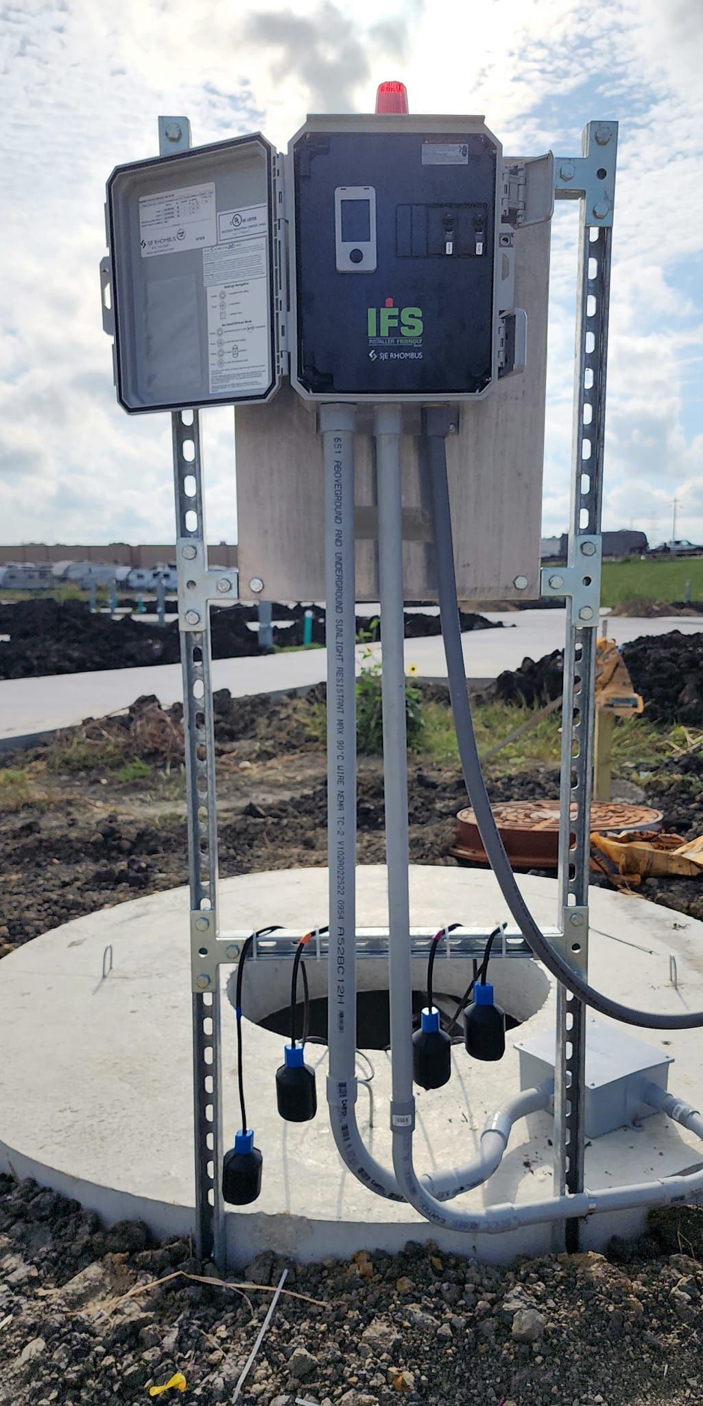 A large electrical box is sitting on top of a concrete platform.