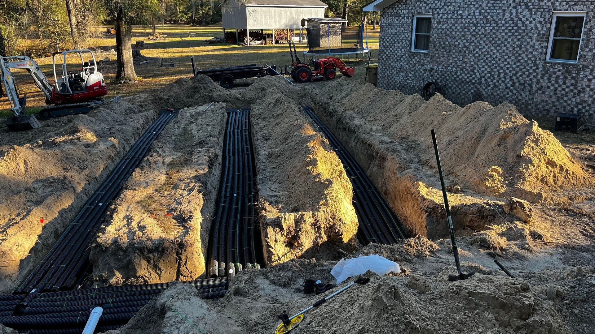 A large pile of dirt is sitting in front of a house.