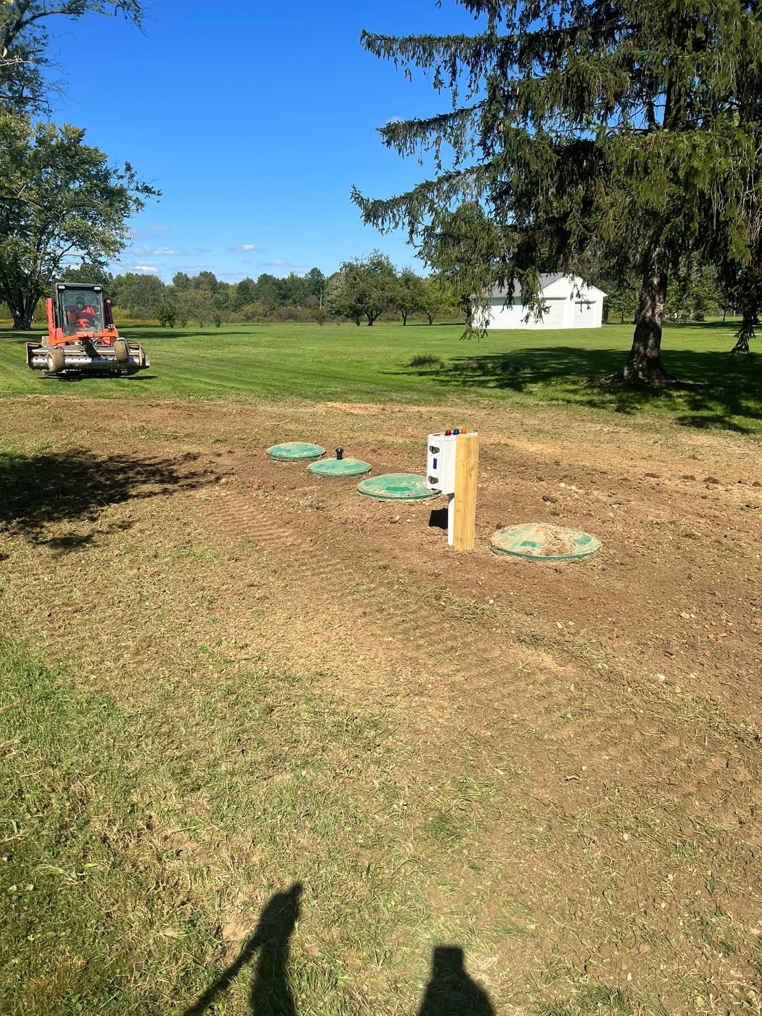 A tractor is parked in the middle of a grassy field.