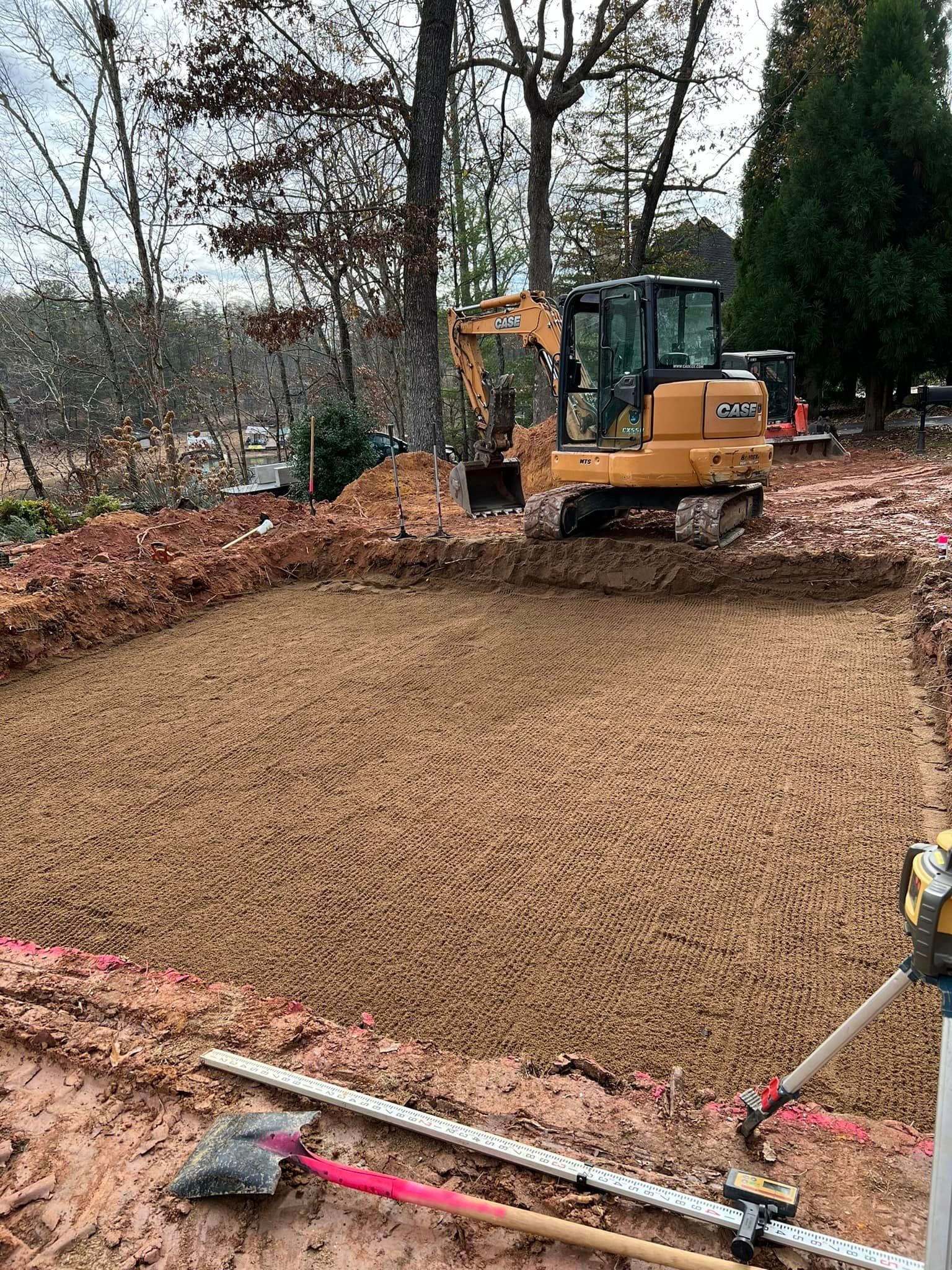 A bulldozer is digging a hole in the dirt on a construction site.