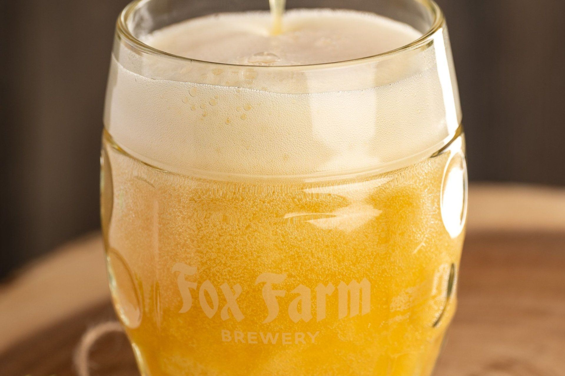 a glass that says fox farm brewery on it