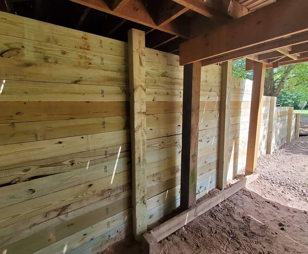 a wooden fence is being built under a roof