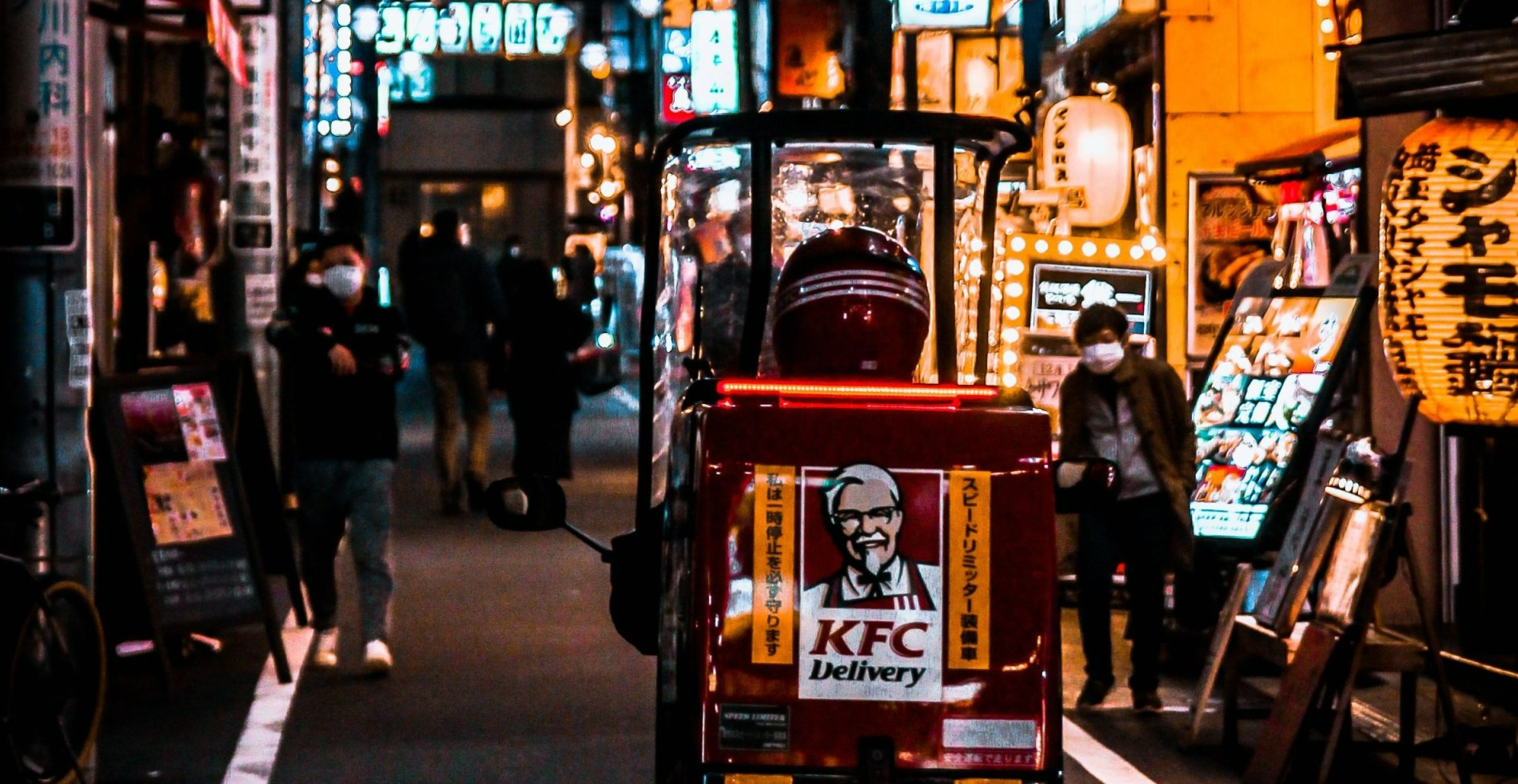 a kfc delivery truck is parked on the street