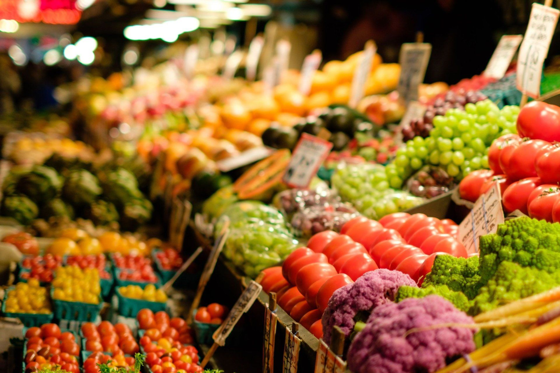 a variety of fruits and vegetables are for sale at a market