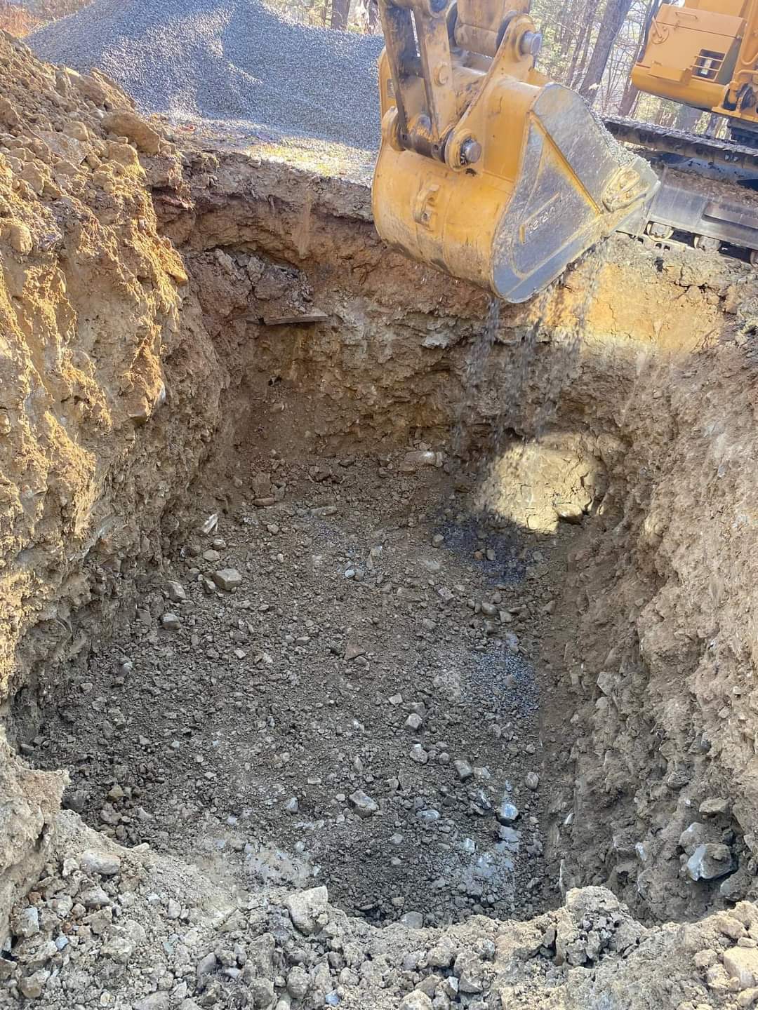 Two men are working on a manhole cover next to a truck.