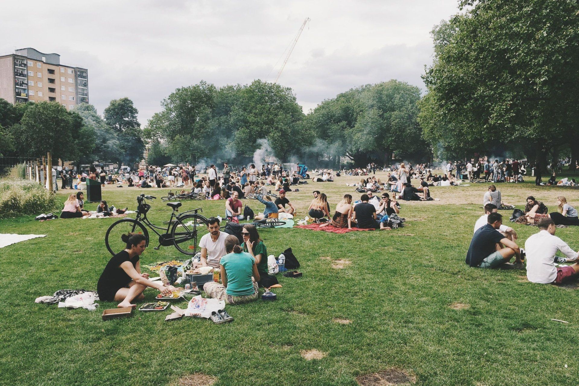 a group of people are having a picnic in a park