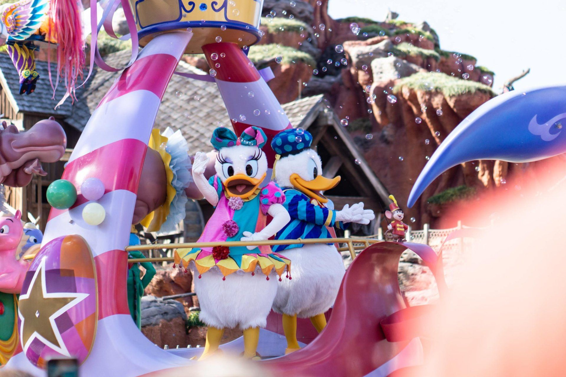 daisy duck and mickey mouse are on a float in a parade
