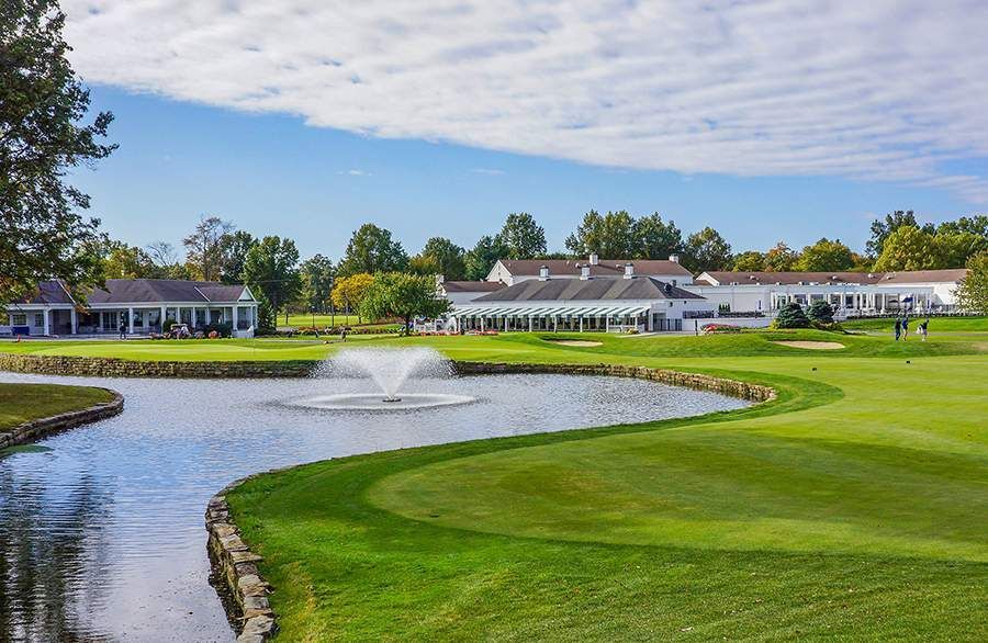 A golf course with a fountain in the middle of it