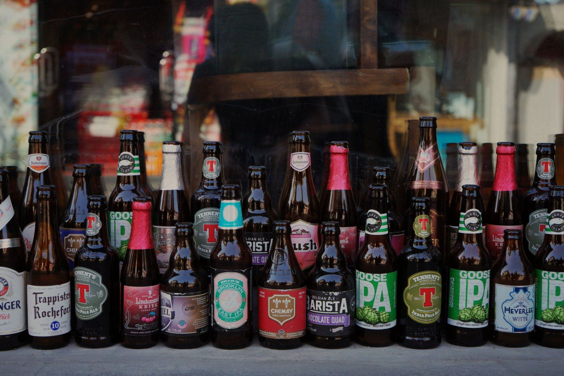 a row of bottles of beer including goose ipa