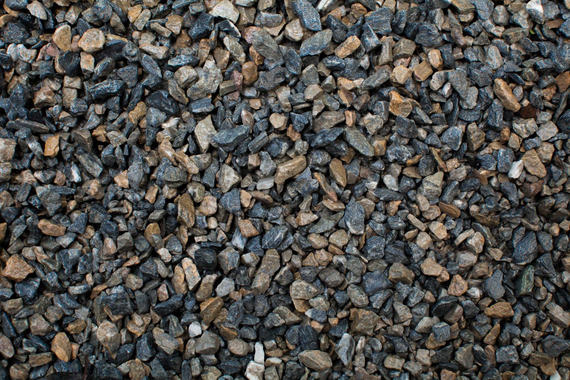 A pile of gravel is sitting on the ground.