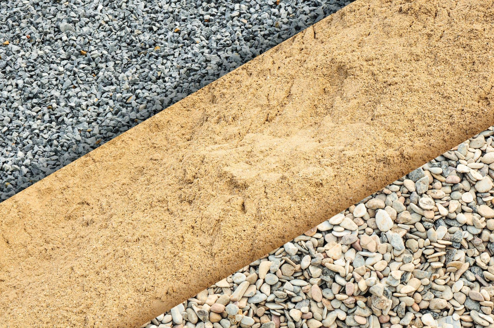 A close up of three different types of gravel and sand.