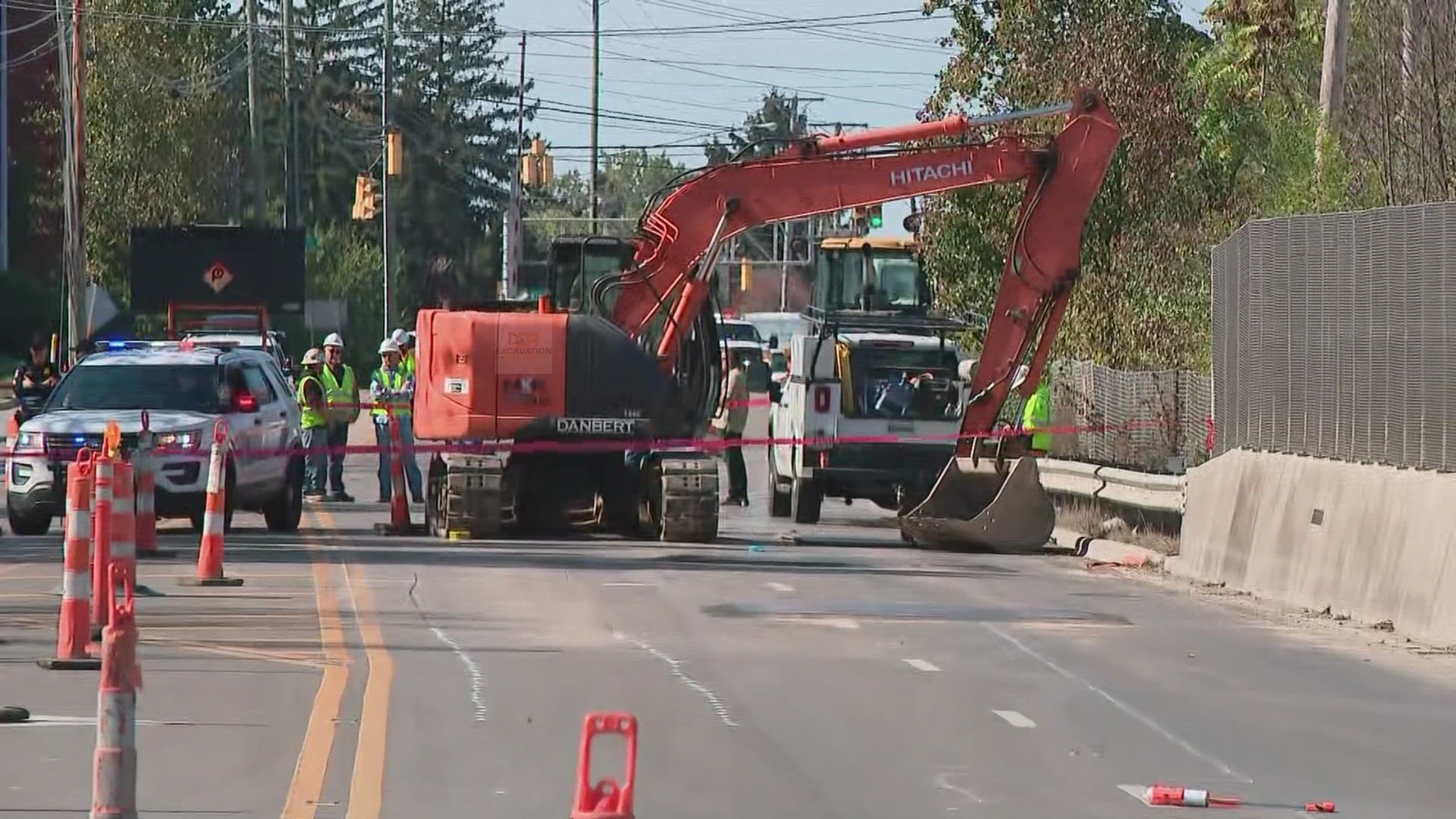 A group of construction workers are working on a road.