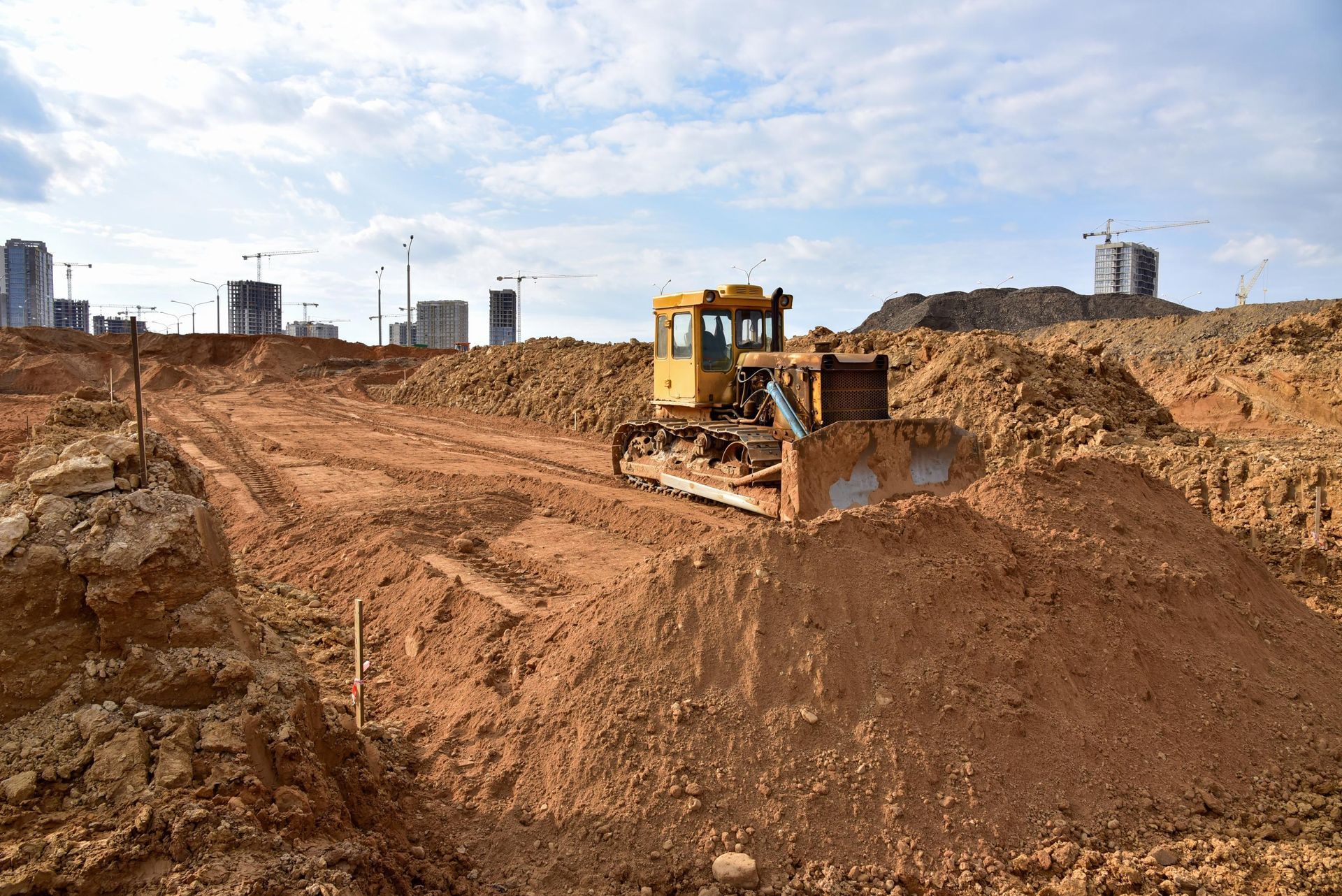 A bulldozer is moving dirt on a construction site.