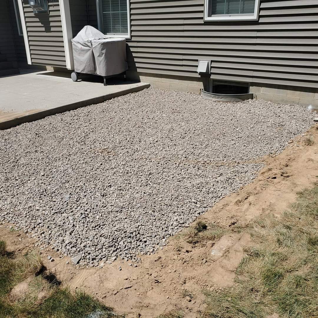 a large pile of gravel is in front of a house