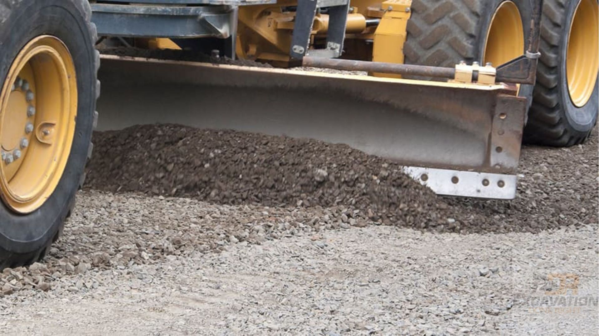 A bulldozer is moving gravel on a road