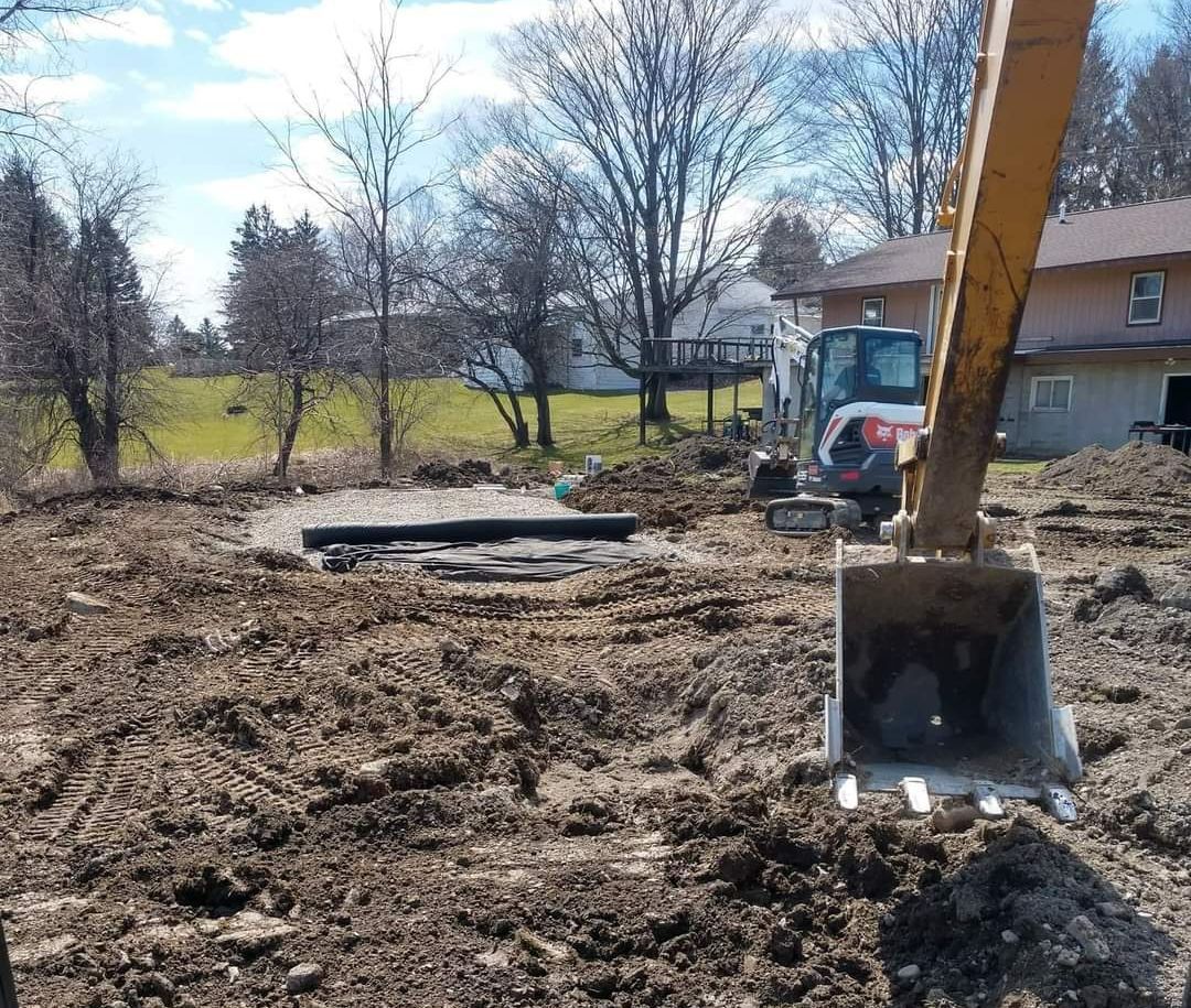 a bobcat excavator is digging in the dirt in front of a house