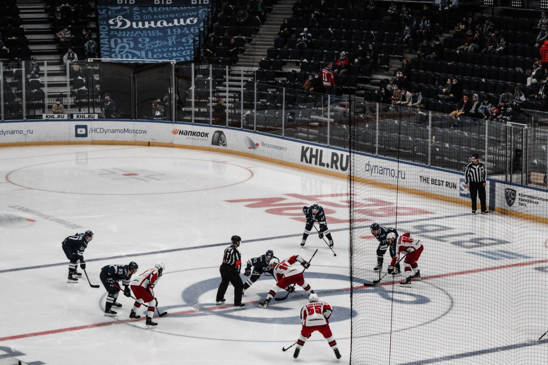 a hockey game is being played in front of a banner that says dynamo