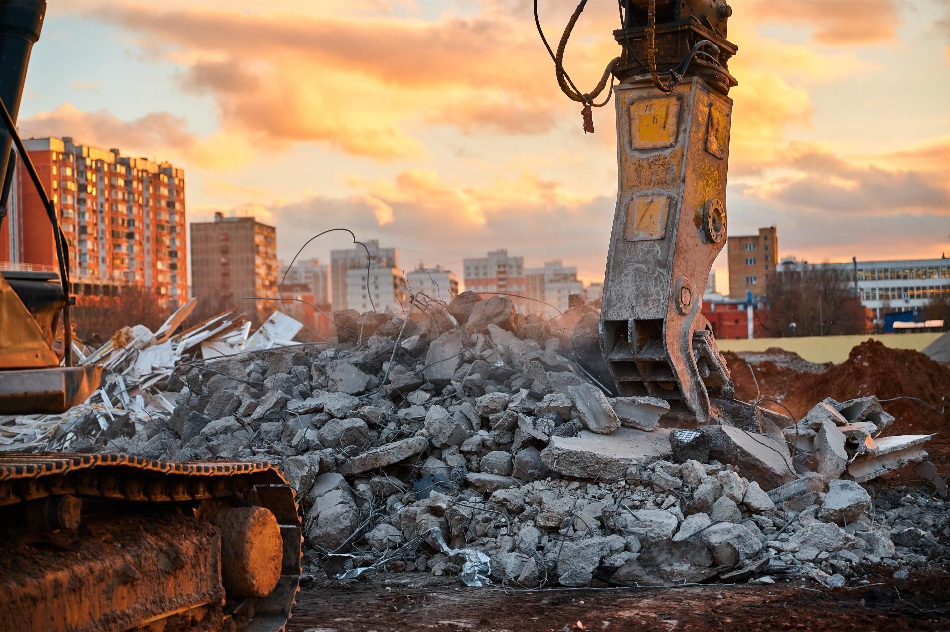 a large pile of rubble is being demolished by a large excavator with the number 7 on it