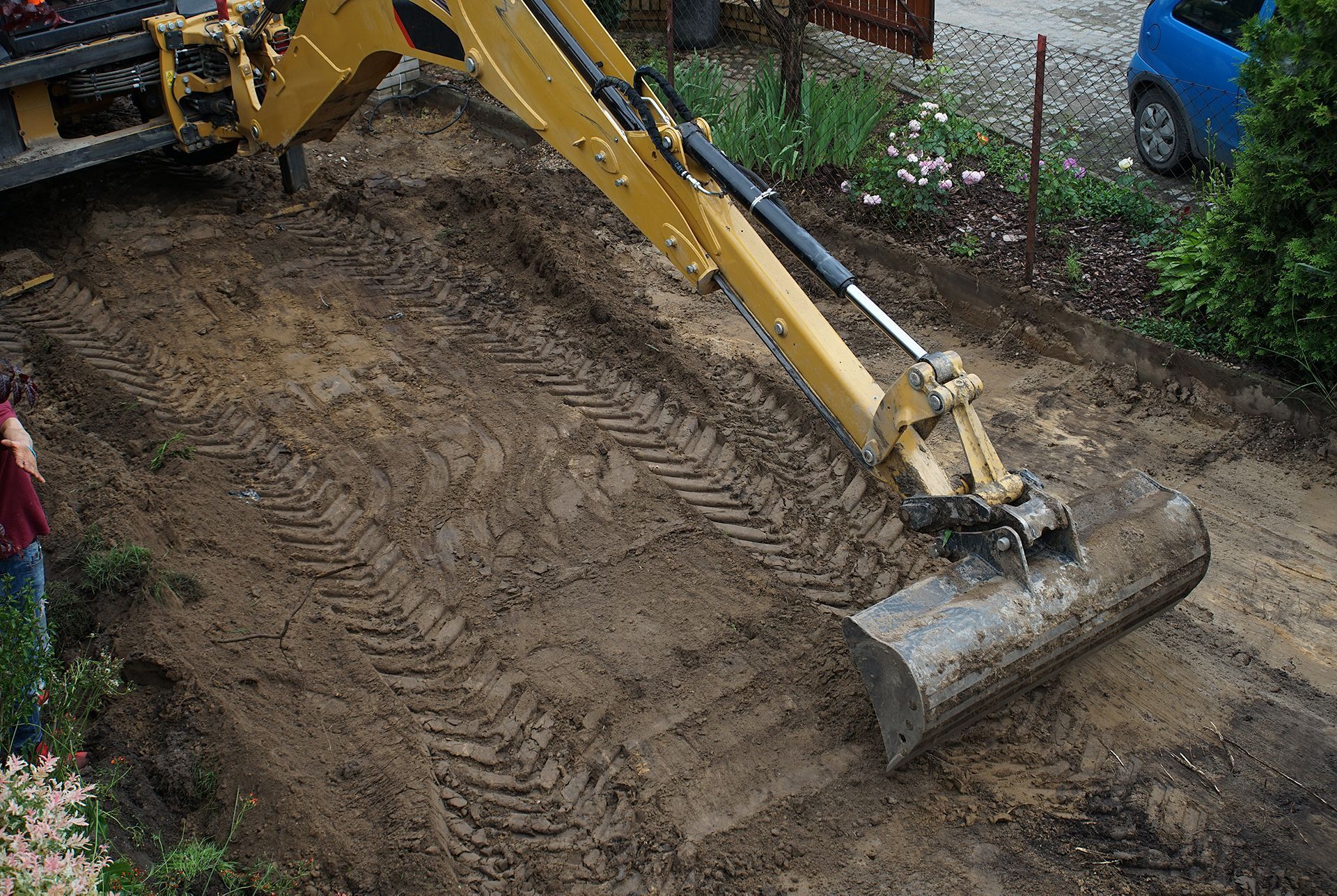 a yellow excavator is digging a hole in the ground