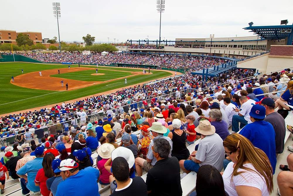 A crowd of people are watching a baseball game in a stadium