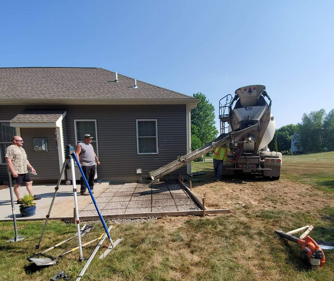 a concrete mixer is pouring concrete in front of a house