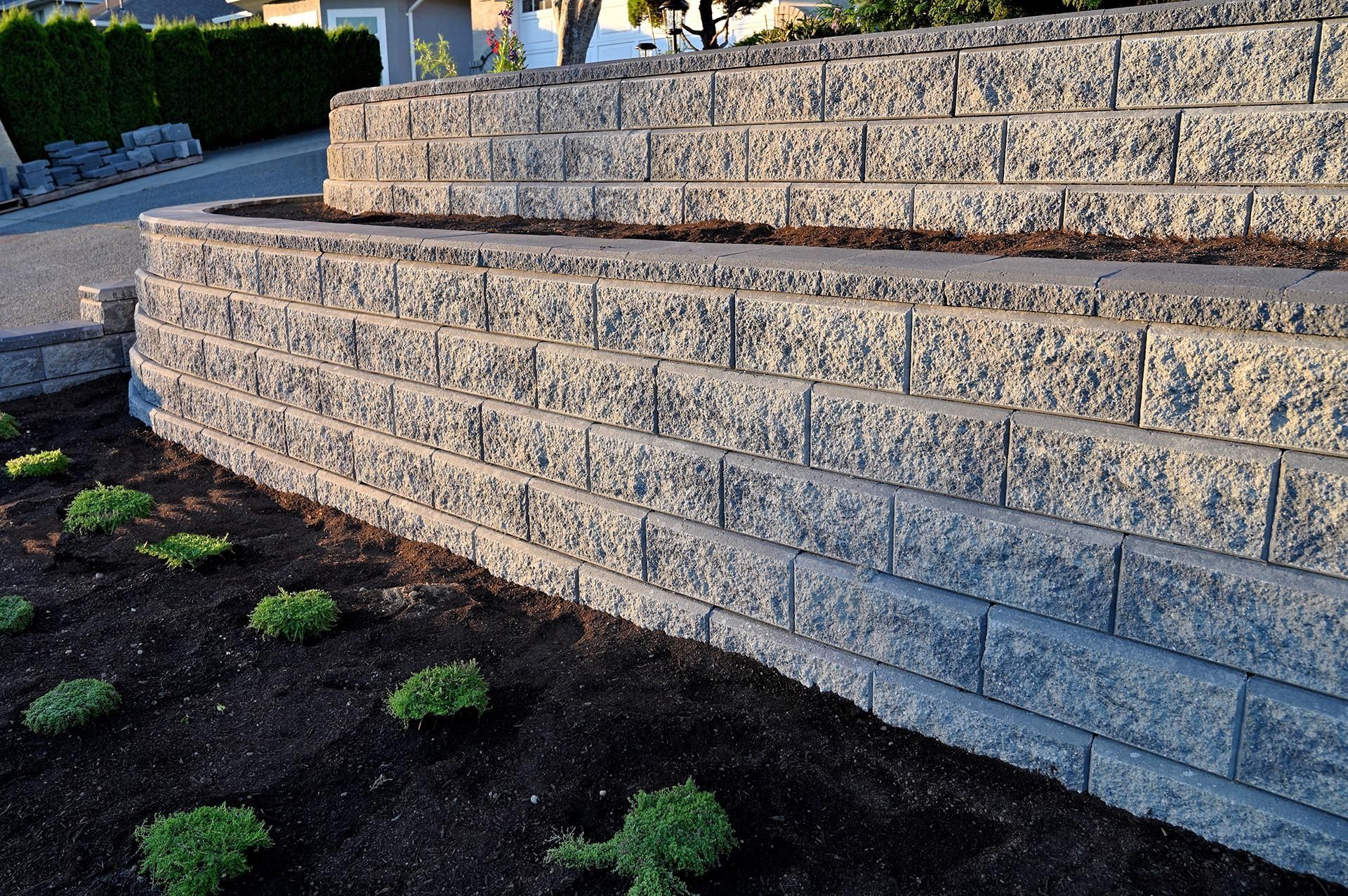 a brick wall with a planter in the middle of it