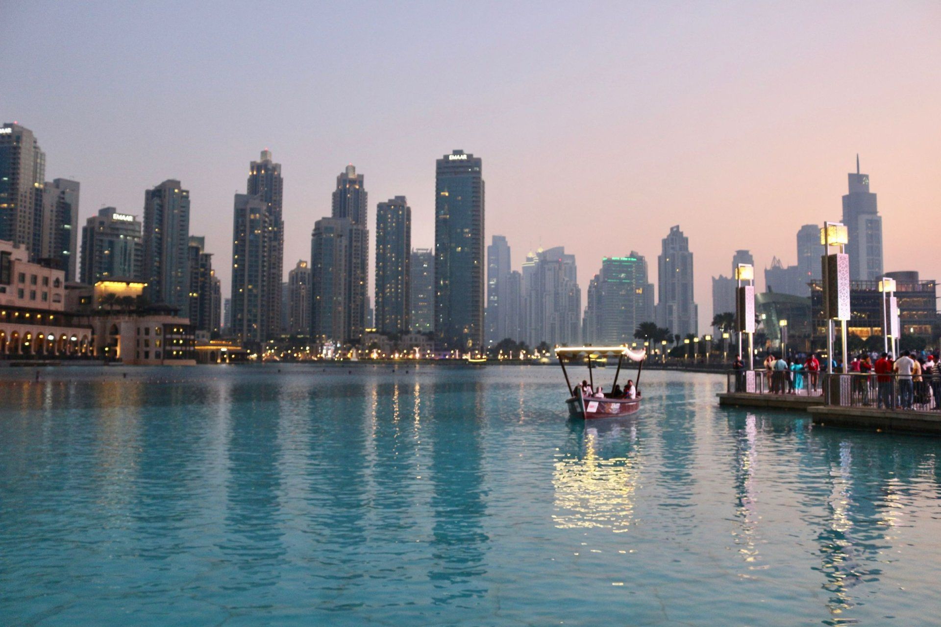 a city skyline with a boat in the foreground