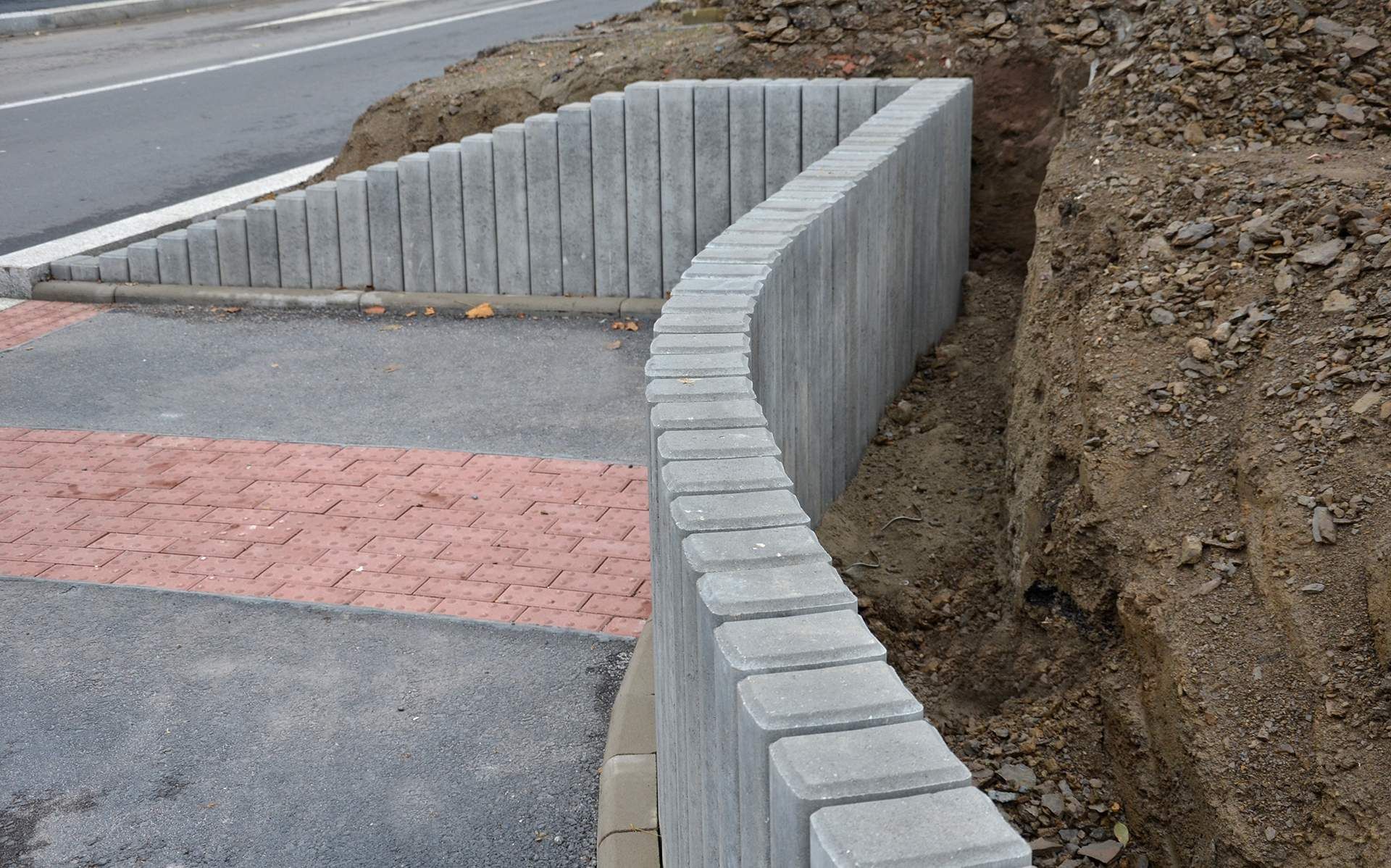 a concrete wall is being built next to a road