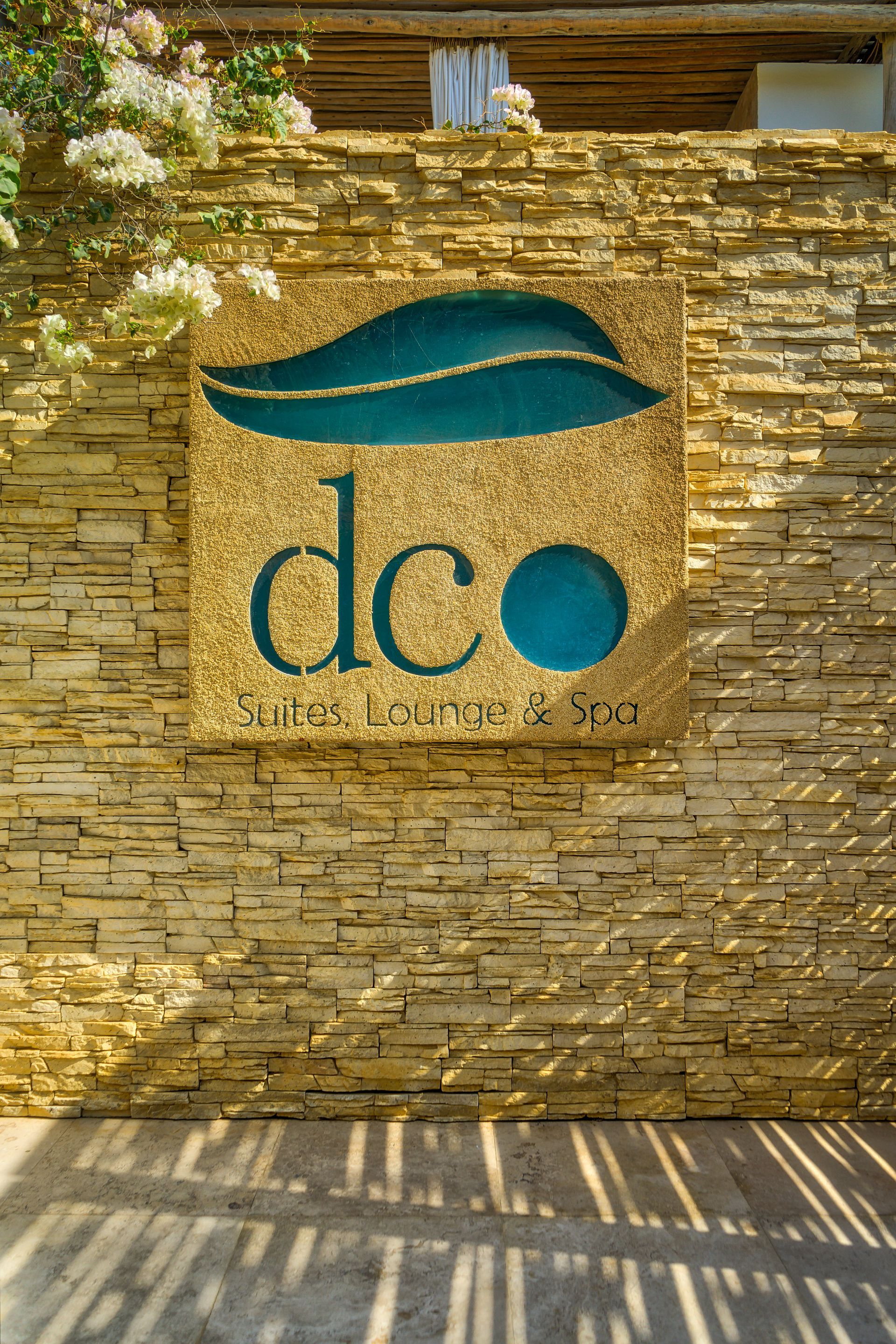 A brick wall with a sign that says dco on it