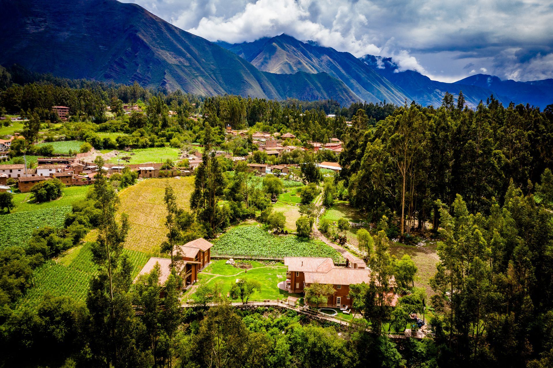An aerial view of a village with mountains in the background