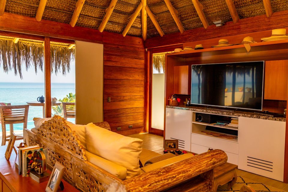 A living room with a couch and a flat screen tv.