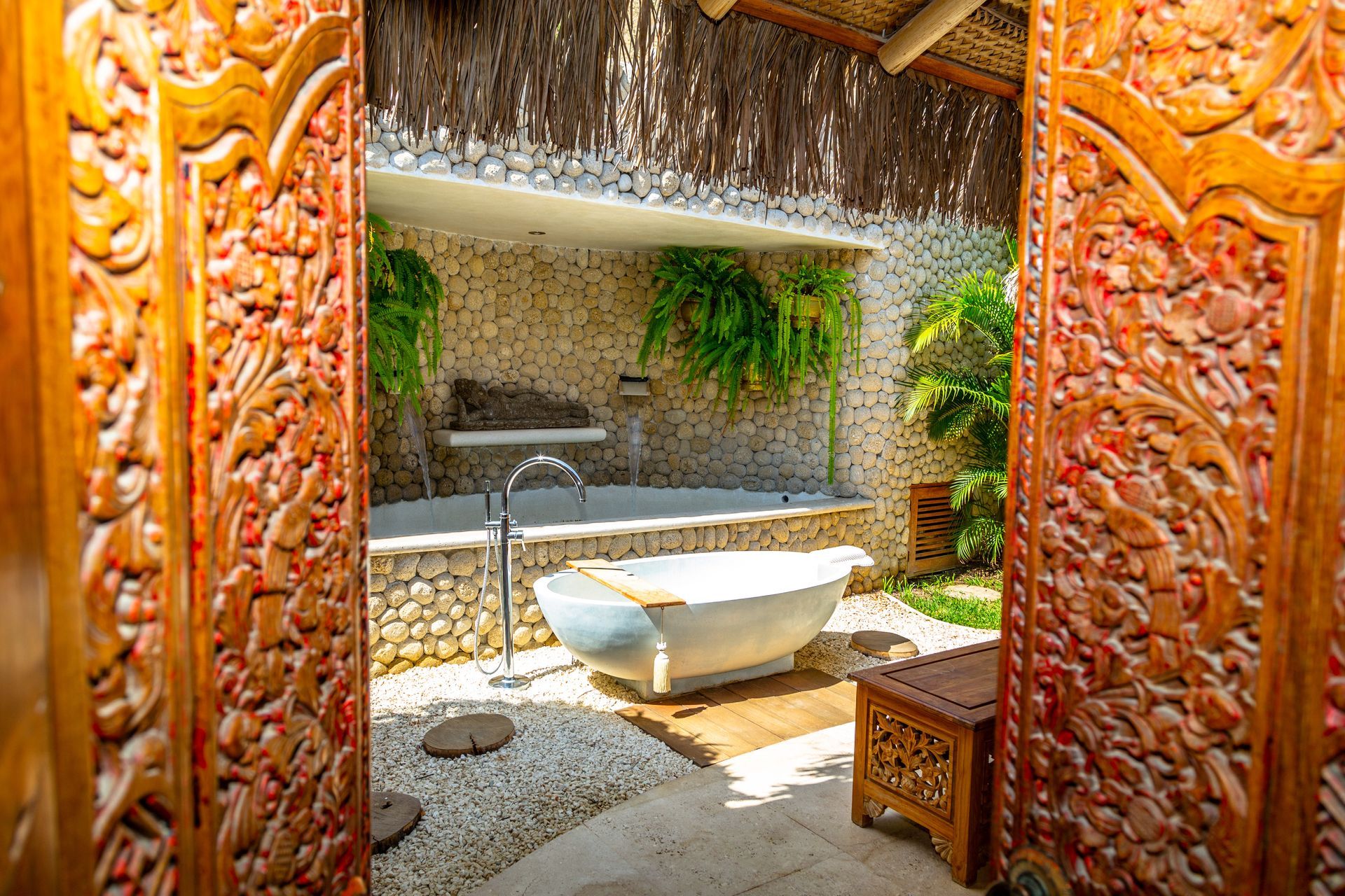 A bathroom with a bathtub and a wooden door.