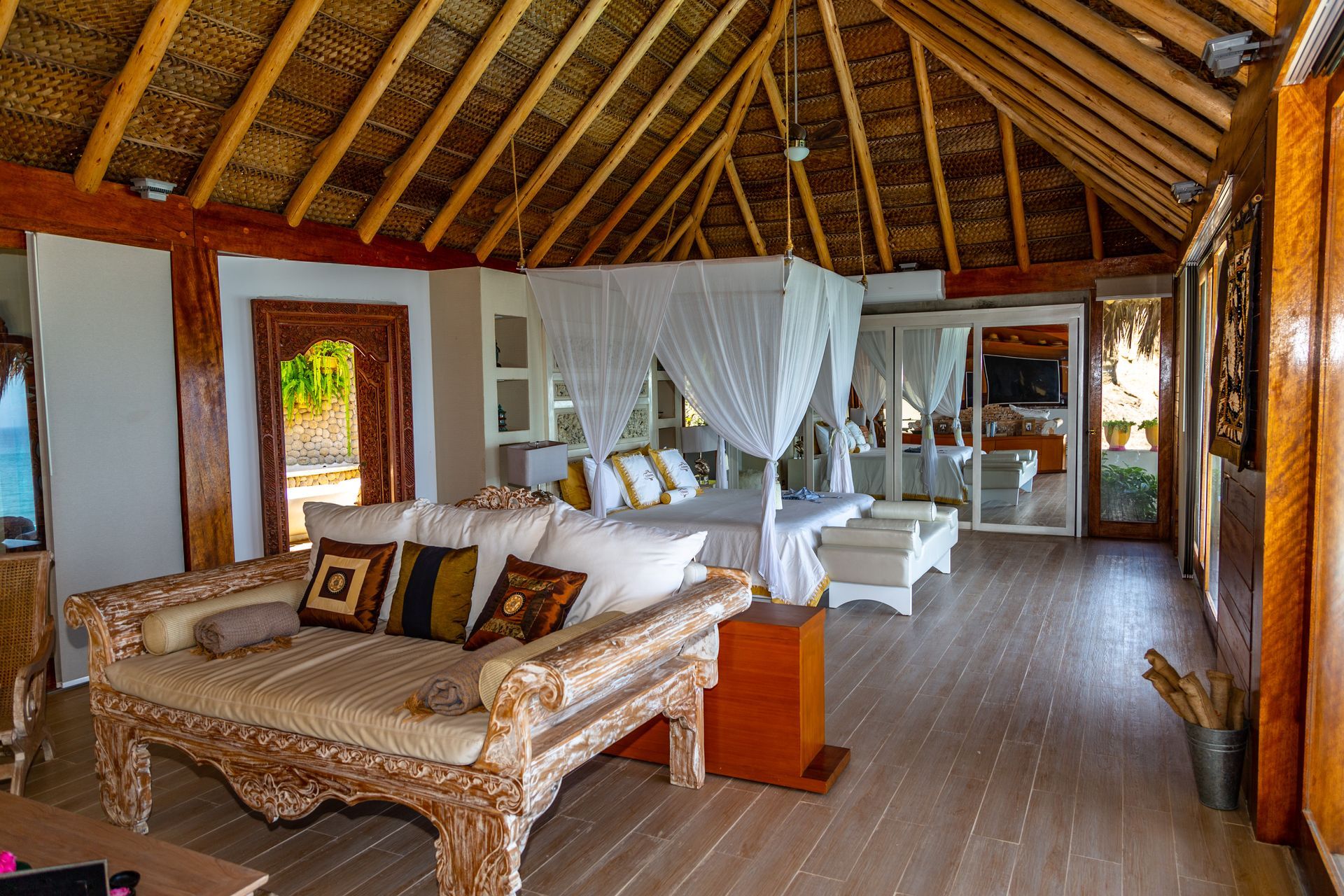A living room with a canopy bed and a couch