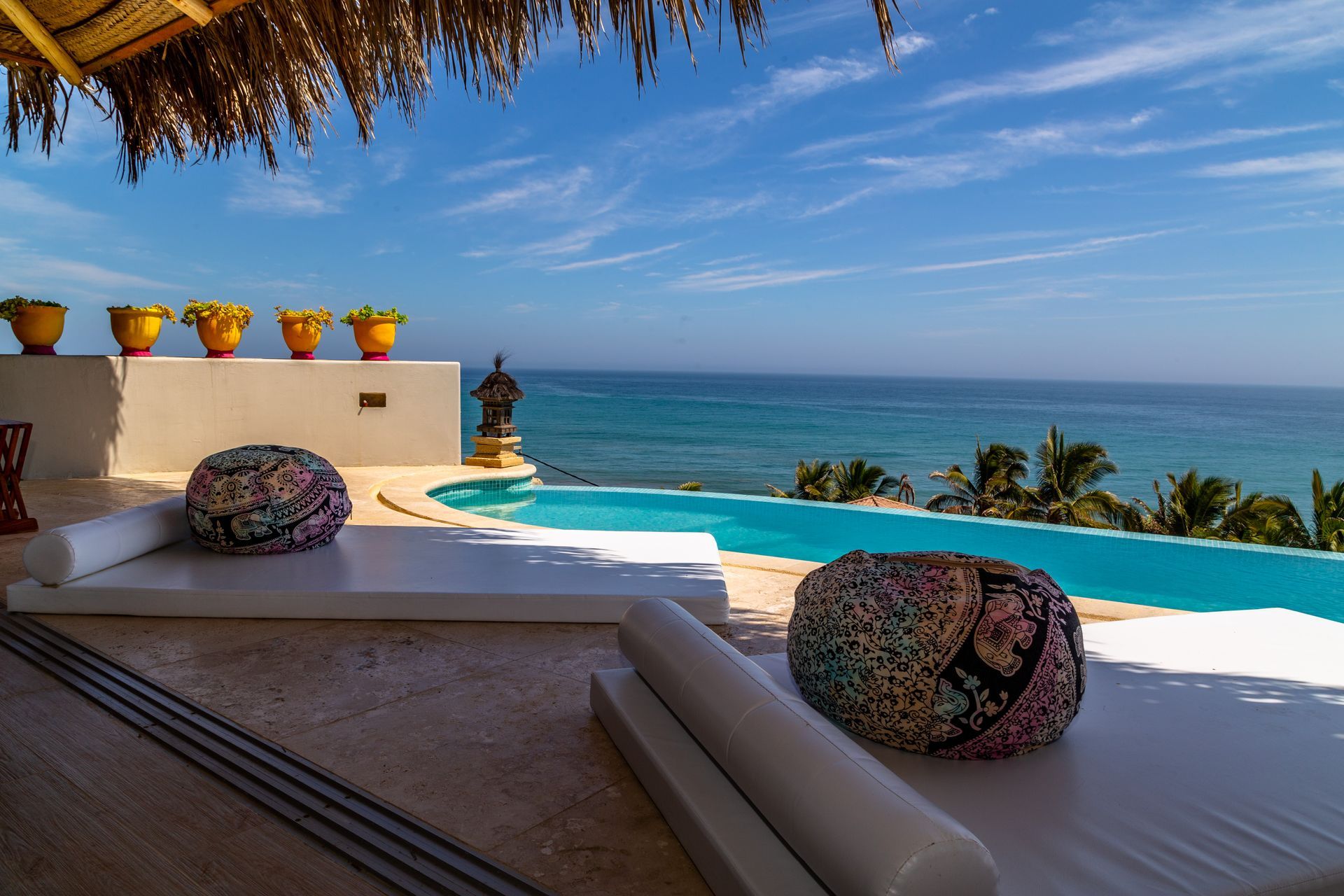 There is a swimming pool with a view of the ocean.
