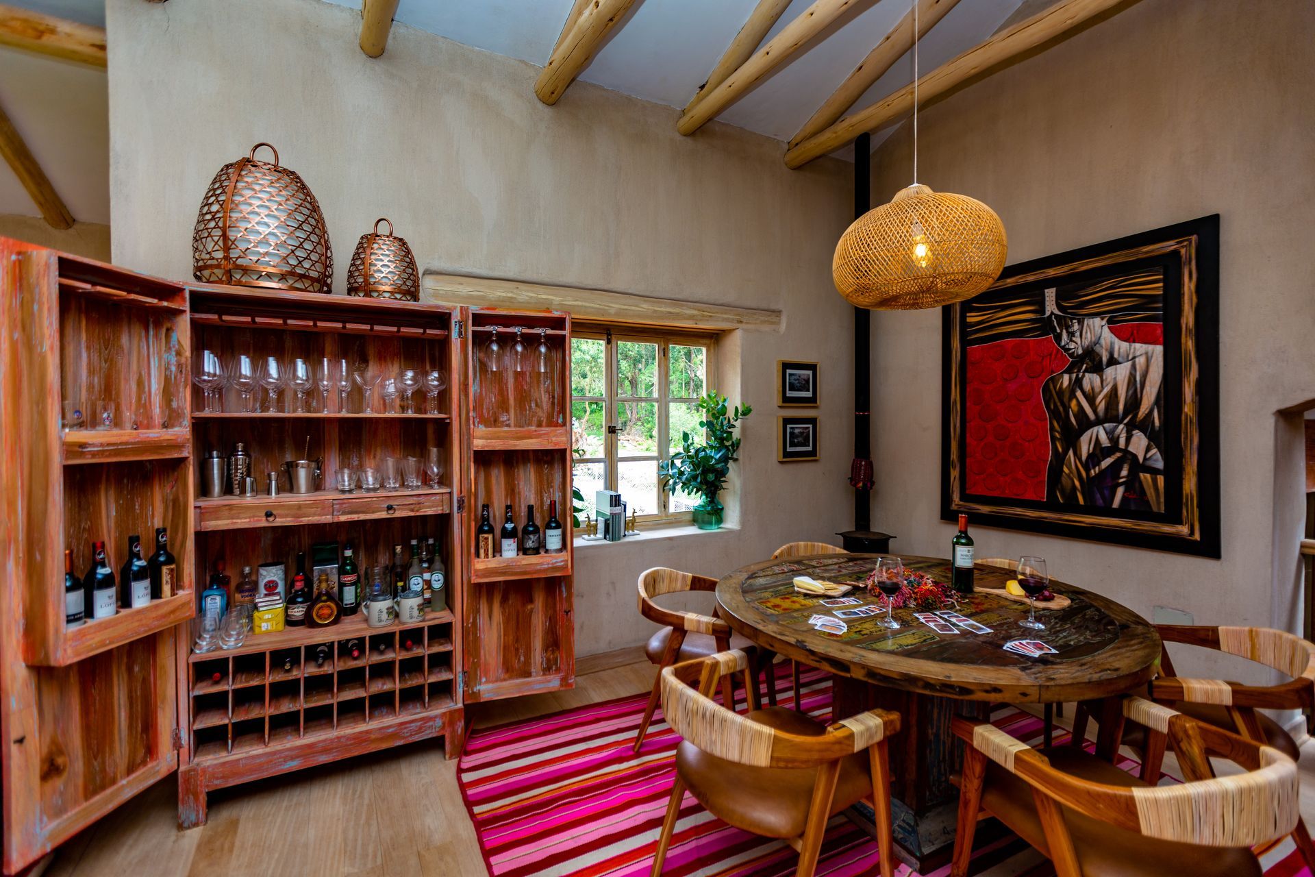 A dining room with a table and chairs and a wine rack