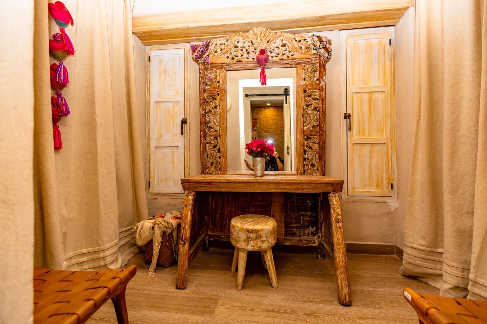 A room with a wooden table and a mirror.