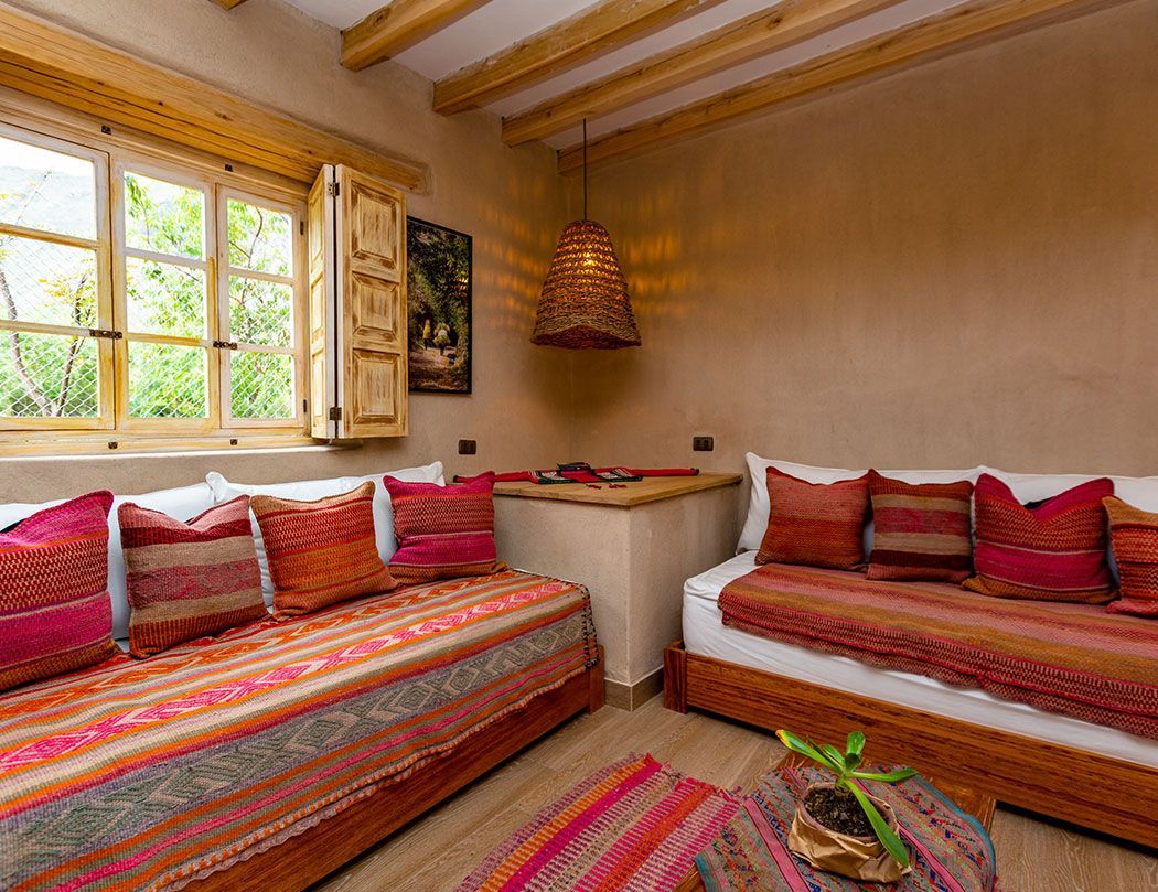 A living room with two couches , a table and a window.