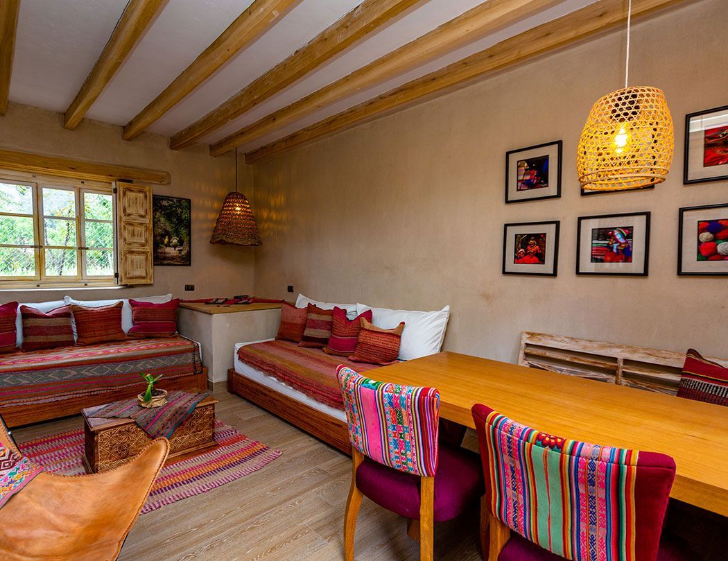 A living room with a couch , table and chairs.