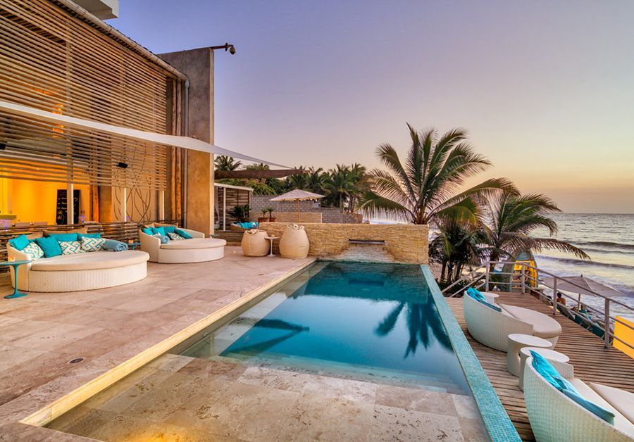 There is a large swimming pool in the middle of the beach.