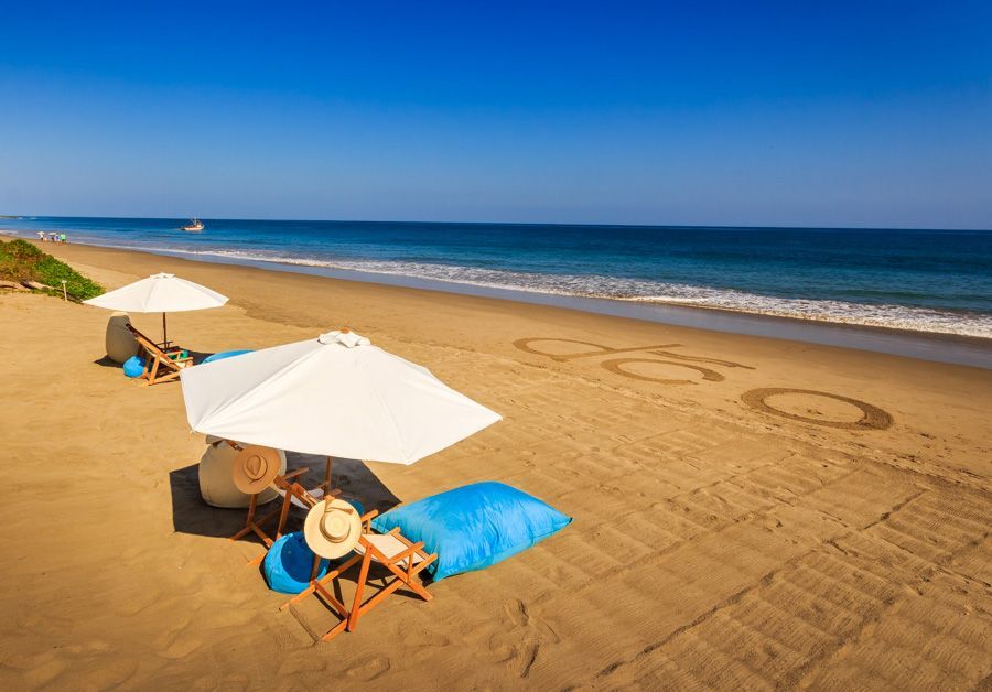 A beach with umbrellas and chairs on it