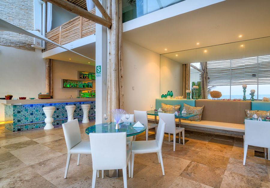 A dining room with tables and chairs and a bar