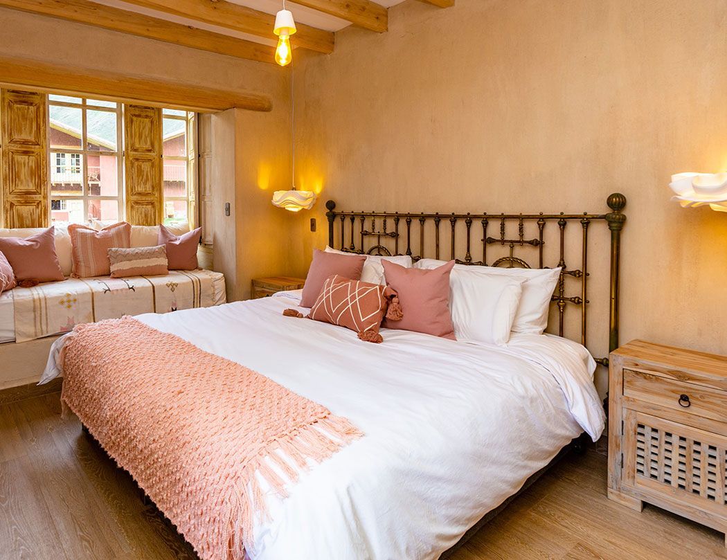 A bedroom with a king size bed and a window.