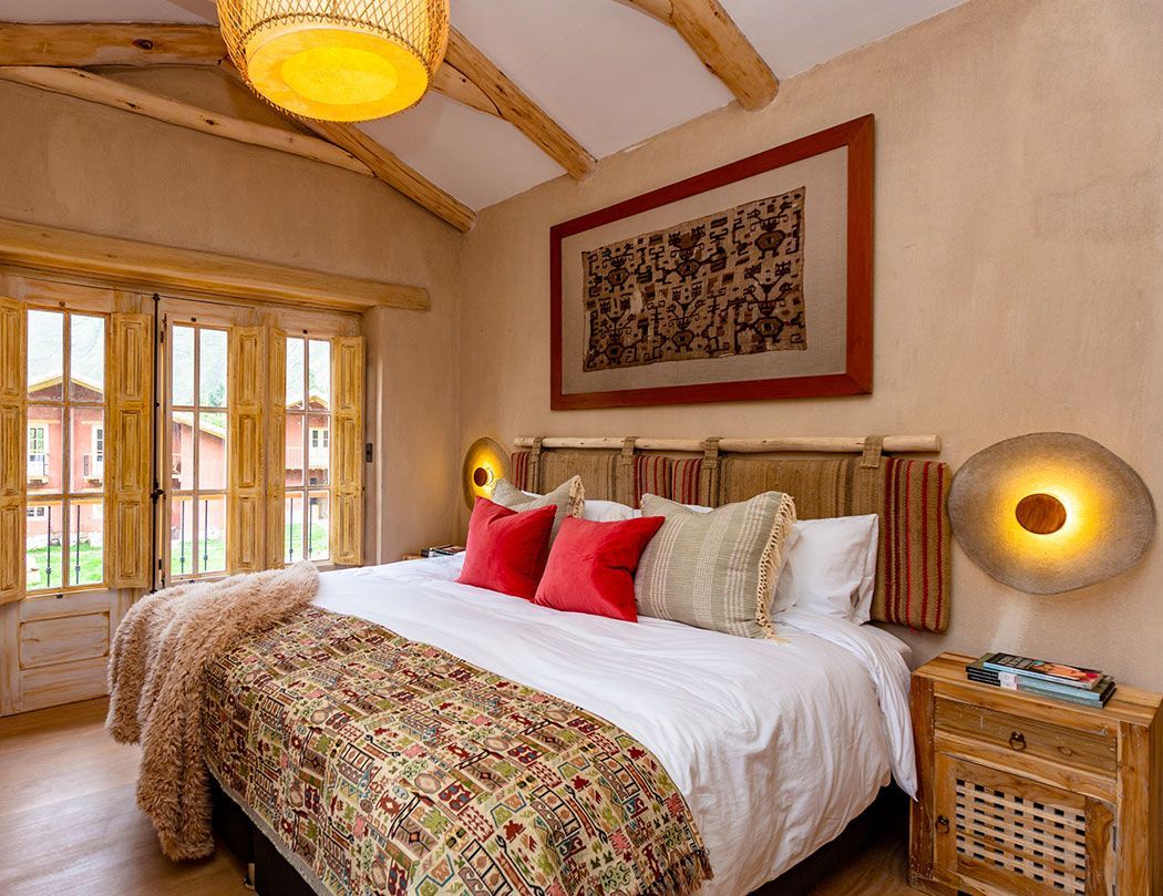 A bedroom with a large bed and a picture on the wall.