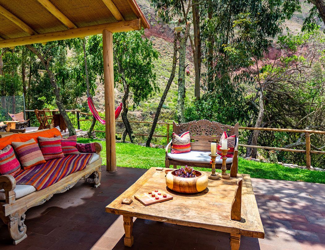 There is a couch and a table on the patio.
