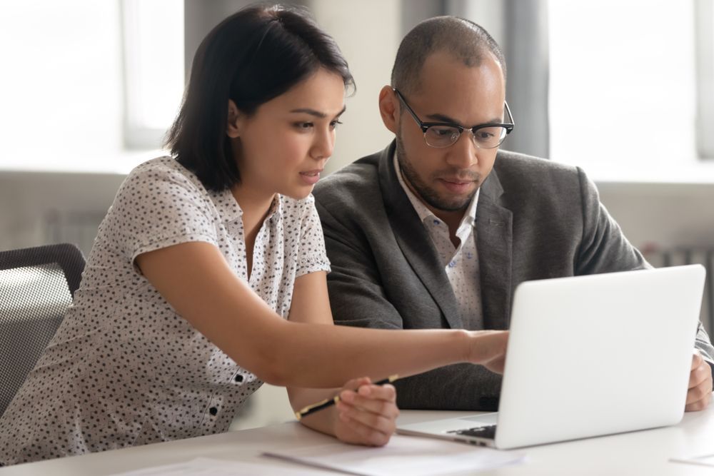Woman Points to Laptop Screen — Midcoast Financial Planning Group in Forster, NSW