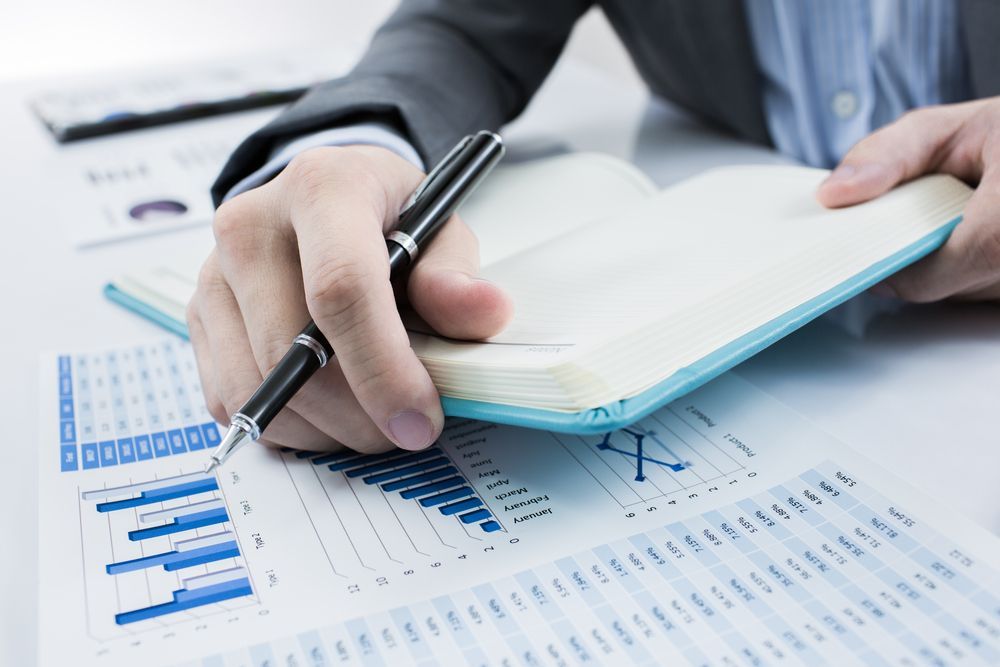 Person Writing in a Notebook — Midcoast Financial Planning Group in Tuncurry, NSW