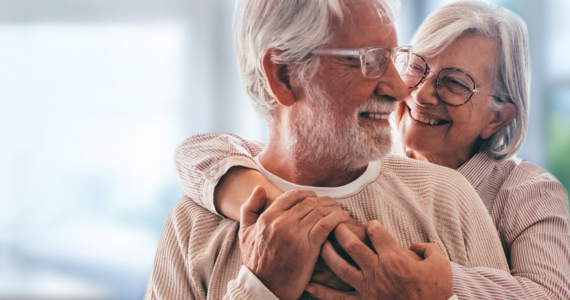 Elderly Couple Embracing — Midcoast Financial Planning Group in Tuncurry, NSW